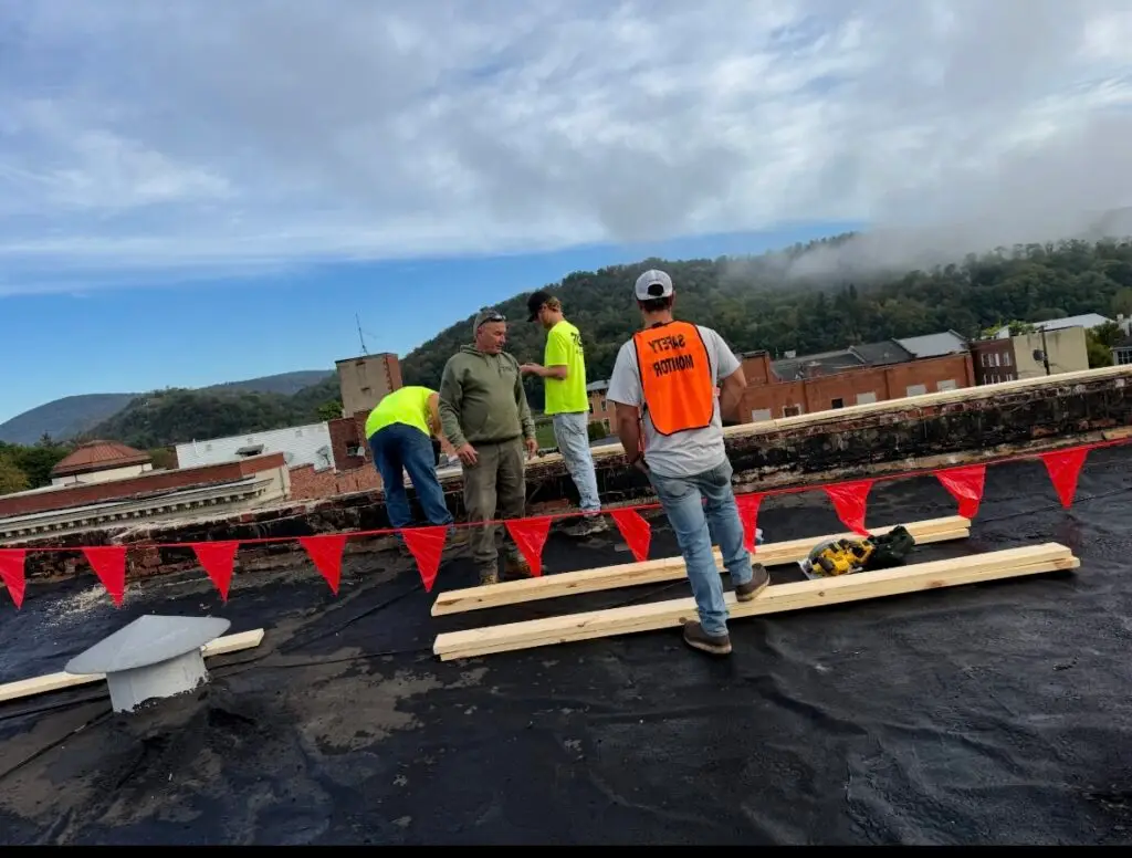 RTG Solutions vice president Robbie Getz serving as safety monitor during a commercial roofing project in Lock Haven, Pennsylvania, ensuring safety compliance and quality workmanship.