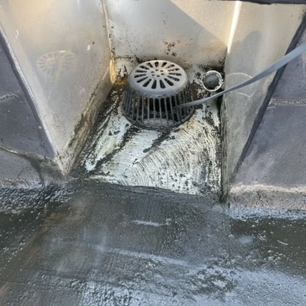 Cleaned roof drain area with repaired field coating on a low-slope modified bitumen roof at Motters Insurance in Jersey Shore, PA by RTG Solutions.