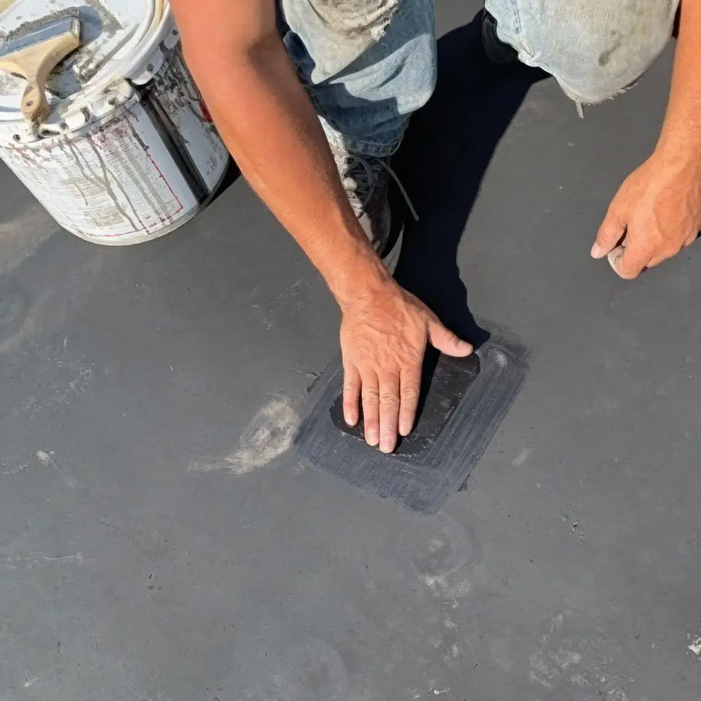 Technician installing a roof patch over a repaired area during preventative maintenance at Motters Insurance in Jersey Shore, PA by RTG Solutions.