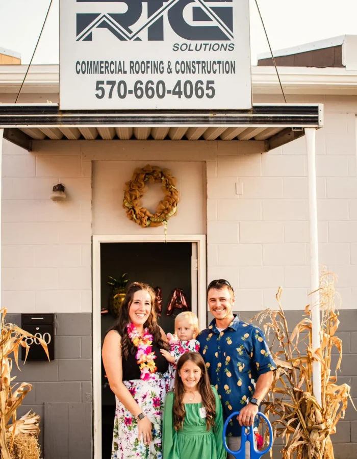 Sarah and Robby with their children at RTG Solutions’ ribbon cutting in Lock Haven, PA, celebrating their woman-owned, veteran-owned commercial roofing company.
