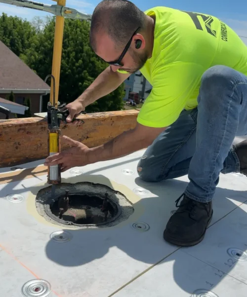 Joe from RTG Solutions sealing a roof drain penetration during the single ply roofing installation at Christ the King Church in Pennsylvania.