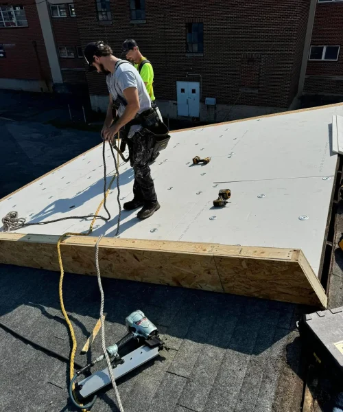 RTG Solutions team performing emergency roof repair on their own headquarters building in Central Pennsylvania, showcasing fast response and expert craftsmanship.