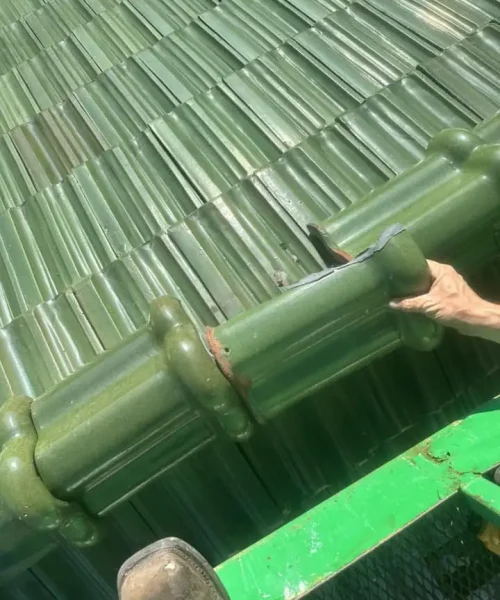Restored corner flashing and new Ludowici green tile installation at Immaculate Conception Church roof.