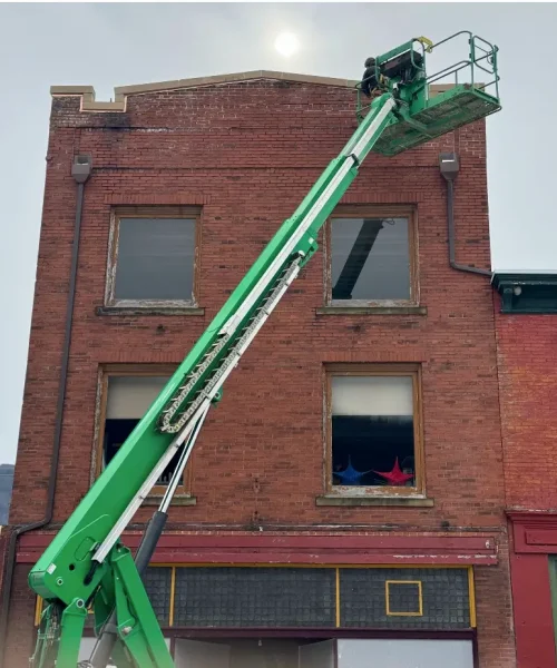 Lift access used by RTG crew to repair exterior façade of Maxwell Building