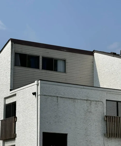 Modified bitumen flat roof system installed on a multi-level commercial building.