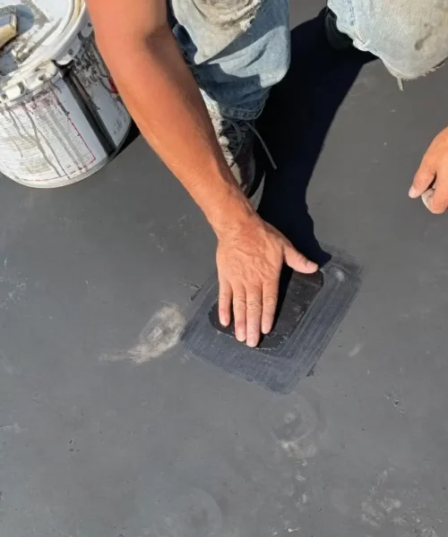 Technician installing a roof patch over a repaired area during preventative maintenance at Motters Insurance in Jersey Shore, PA by RTG Solutions.