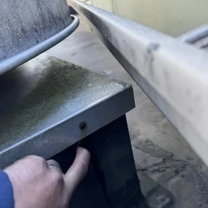 Commercial roof inspection flashing gap | RTG Solutions Commercial roof inspection showing gap beneath metal flashing that could lead to leaks