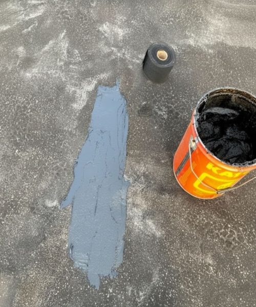 Roof cement applied to a damaged section of low-slope roofing during Redmond’s Roof Repairs in Lock Haven, PA