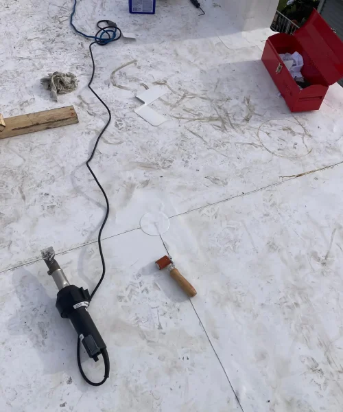 Close-up of TPO roofing seam welding and installation during commercial reroof in Central Pennsylvania