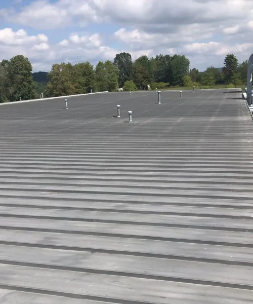 Standing seam metal roof at WERC in Princeton, WV with multiple roof vents, serviced by RTG Solutions for commercial leak repairs and sealing work.